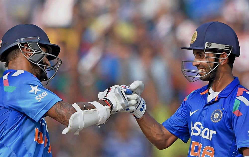 Indian batsman Shikhar Dhawan and Ajinkya Rahane greet each other during 1st ODI match against Sri Lanka in Cuttack.