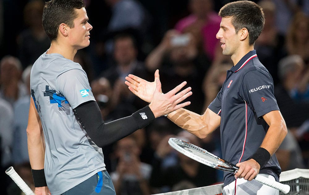 Milos Raonic of Canada, left, congratulates Novak Djokovic of Serbia, after their final match at the ATP World Tour Masters tennis tournament at Bercy stadium in Paris, France.