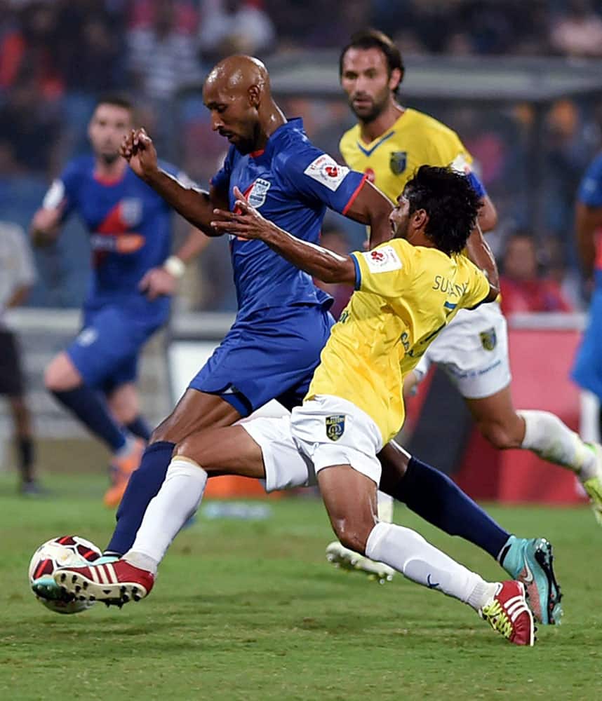 Kerala Blasters FC (yellow) and Mumbai City FC player Nicolas Anelka (blue) vie for the ball during the ISL match in Mumbai.