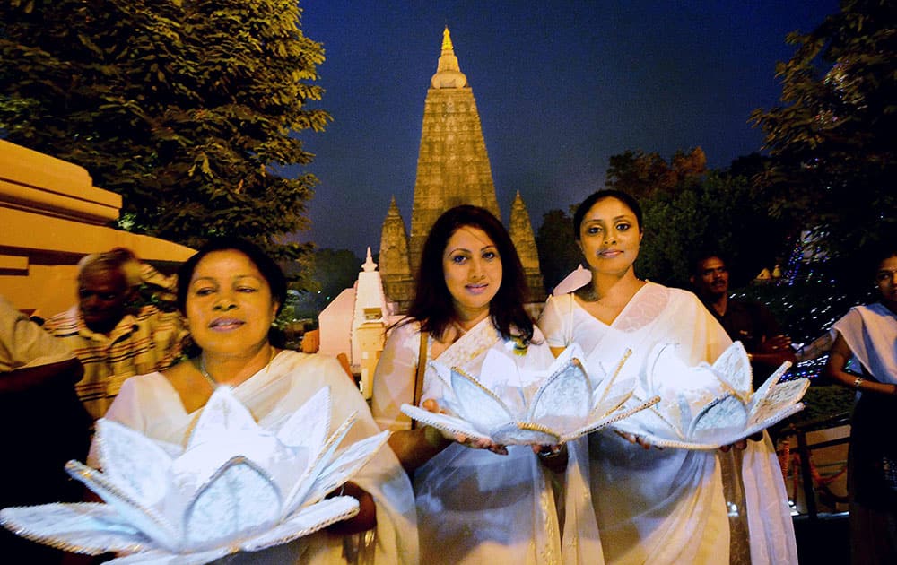 Sri Lankan devotees during a candle light procession at Mahabodhi temple during robe offering ceremony in Bodh Gaya.