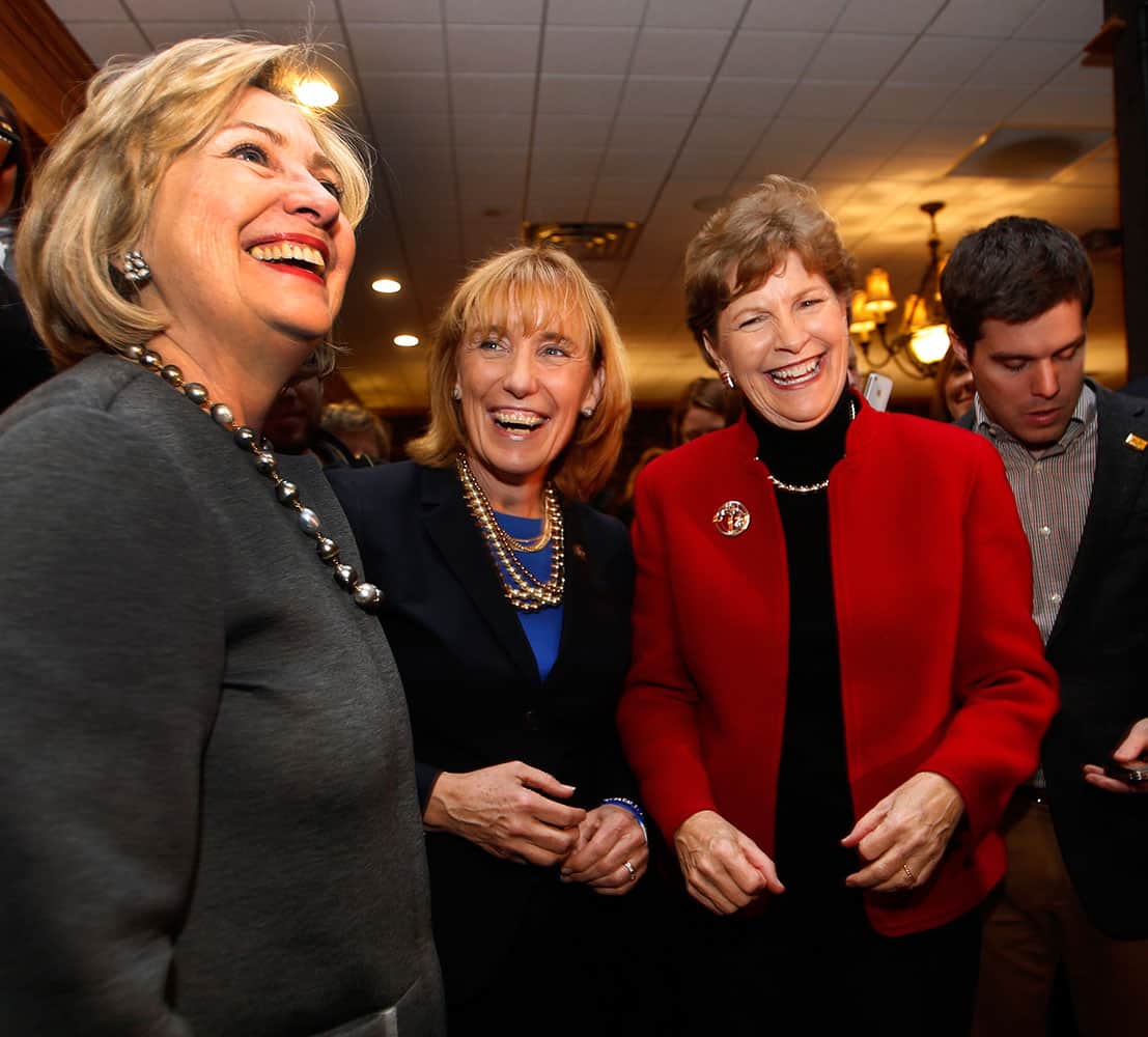 Hillary Rodham Clinton, left, talks to voters with U.S. Sen. Jeanne Shaheen, D-N.H., right, and Gov. Maggie Hassan, D-N.H., at the Puritan Backroom Restaurant, in Manchester, N.H.
