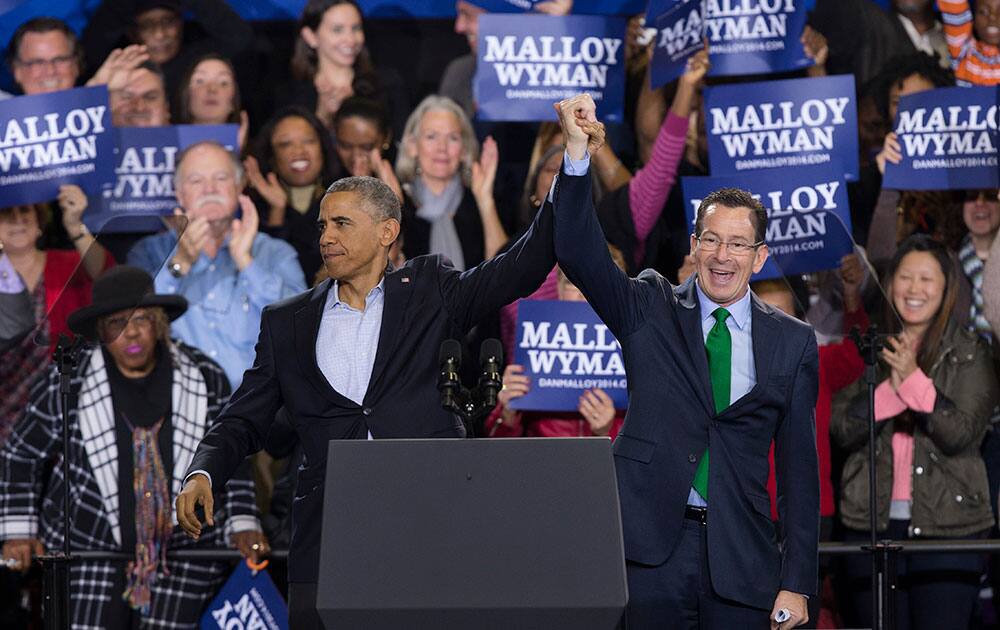 President Barack Obama, left, and Connecticut Gov. Dannel P. Malloy wave to cheering supporters during a rally supporting the Malloy's reelection campaign at Central High School, in Bridgeport, Conn.