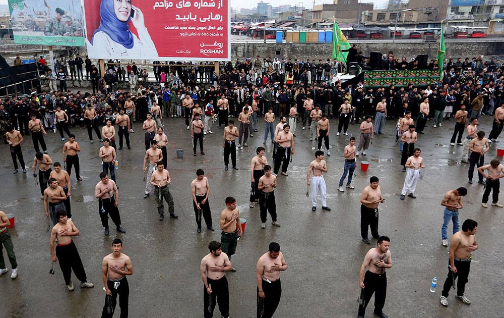 Afghan Shiites prepare to flagellate themselves with chains and knives during the holy day of Ashoura in Kabul, Afghanistan.