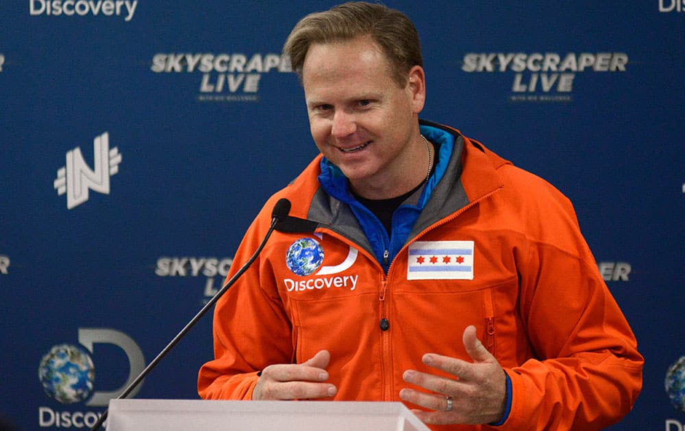 Daredevil Nik Wallenda talks to the media during a press conference after his tight rope walk in Chicago.