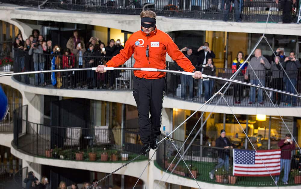 This photo provided by Discovery Communication shows Nik Wallenda walking across the Chicago skyline blindfolded for Discovery Channel's Skyscraper Live with Nik Wallenda.