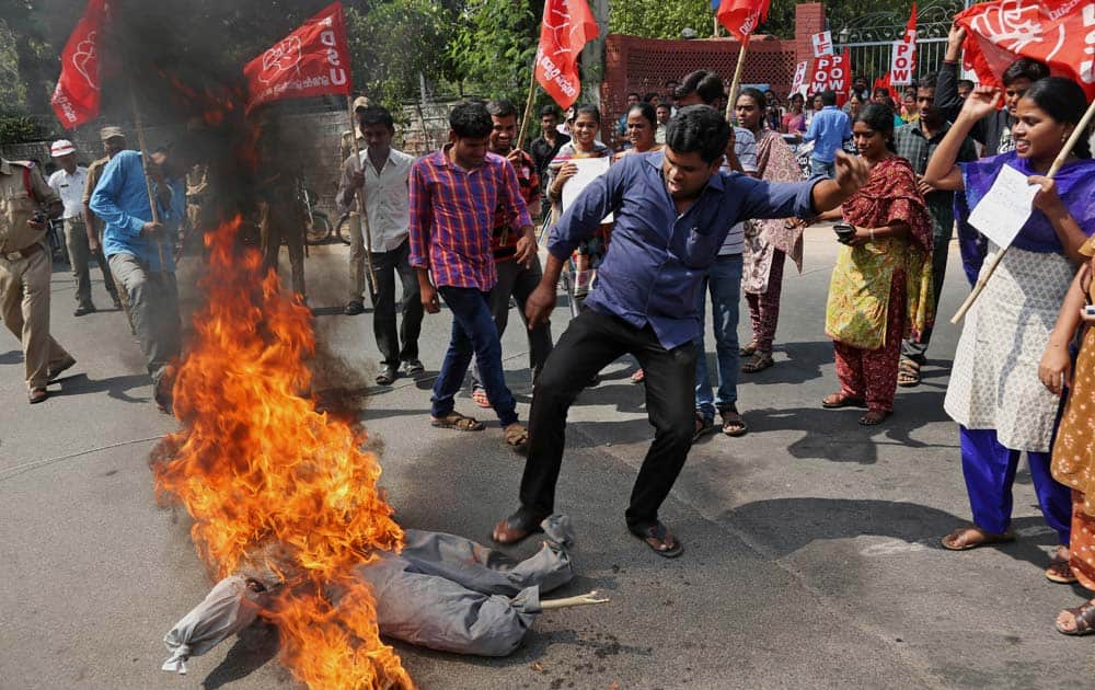 Indian students of Progressive Democratic Students Union (PDSU) raise slogans and burn an effigy during a protest against a gang rape of a student, outside the English and Foreign Languages University (EFLU) in Hyderabad, India.