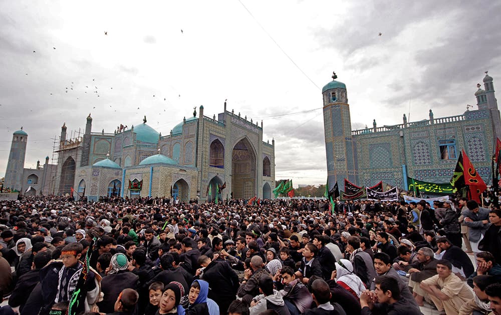 Afghan Shiite men listen to a cleric during the holy day of Ashoura in Mazar-i-Sharif, Afghanistan.