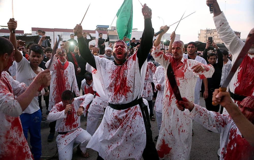 Iraqi Shiite faithful worshippers cut themselves with swords and knives to show their grief during the holy day of Ashoura in Basra, 340 miles (550 kilometers) southeast of Baghdad, Iraq.