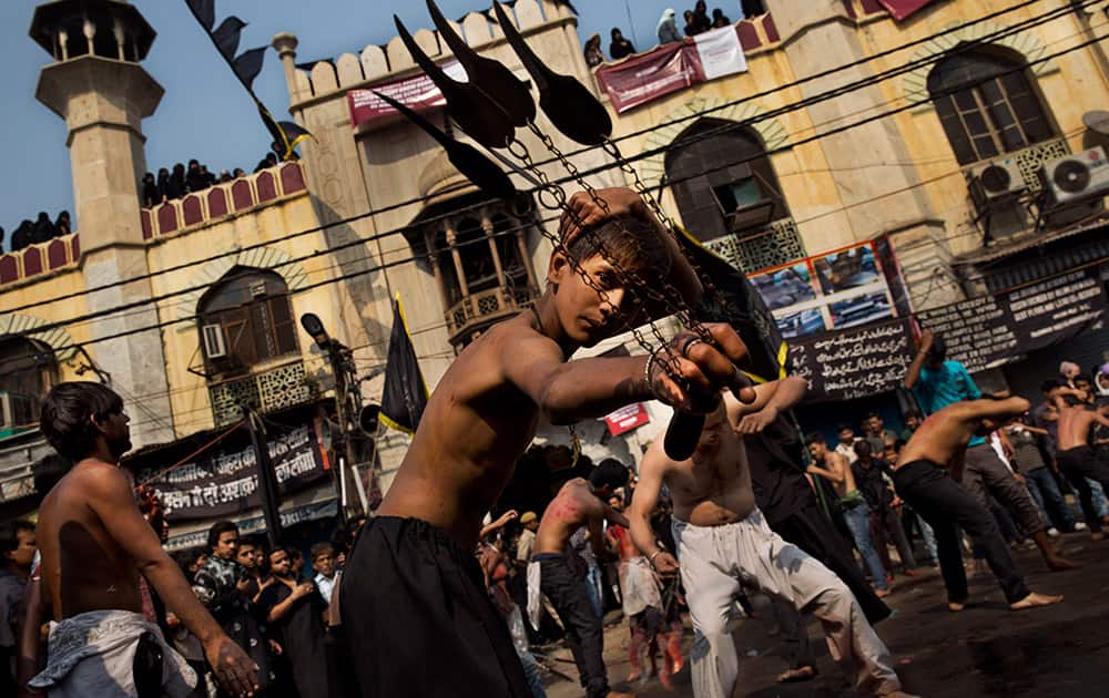A young Shiite Muslim flagellates himself during a procession to mark Ashoura in New Delhi, India.