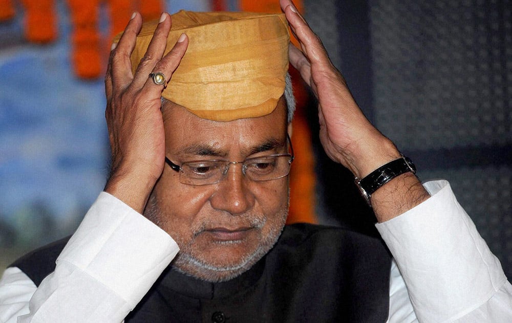 Former Bihar Chief Minister Nitish Kumar adjusts his Mithila cap during inauguration of Vidyapati Parv in Patna.