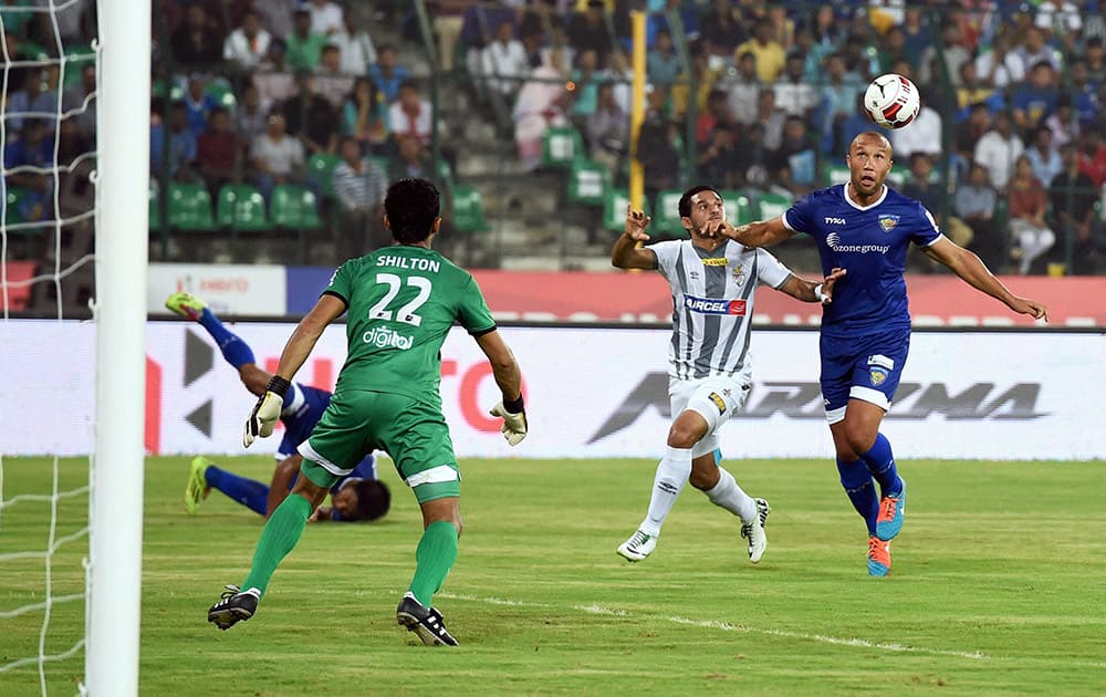 Players of Atletico De Kolkata (white) and Chennaiyin FC football teams compete during their Indian Super League match at Nehuru Stadium in Chennai.