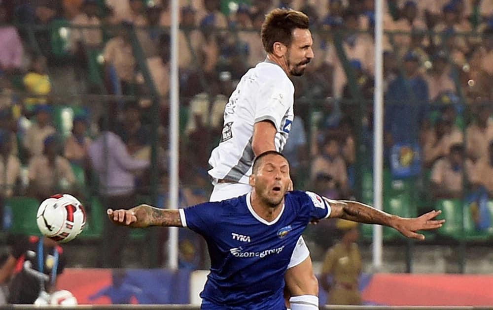 Players of Atletico De Kolkata (white) and Chennaiyin FC football teams compete during their Indian Super League match at Nehuru Stadium in Chennai.