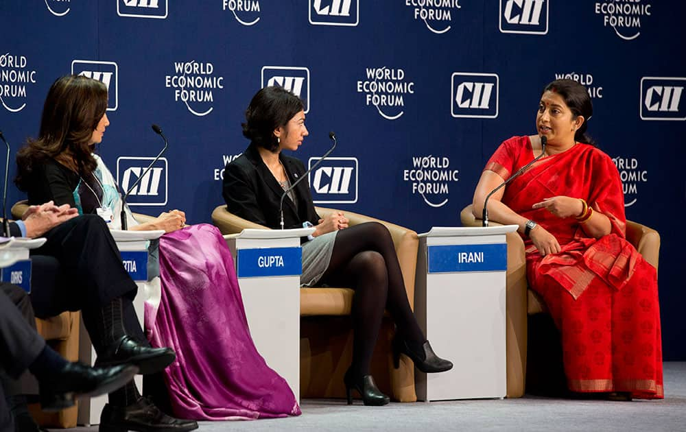 Indian Minister for Human Resource Development Smriti Irani, right, speaks during a panel discussion at the India Economic Summit in New Delhi, India.