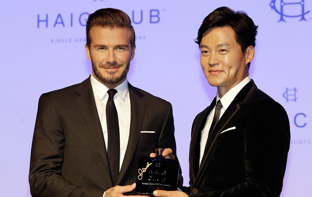 Former England and PSG soccer player David Beckham and South Korean actor Lee Seo-jin pose for photos during a promotional event for a whisky brand in Seoul, South Korea.