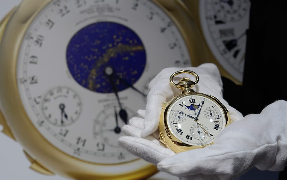 A Sotheby's employee shows the Henry Graves Supercomplication handmade watch by Patek Philippe, which is estimated to sell between 15,600,000 US dollars ,during a preview at Sotheby's, in Geneva, Switzerland.