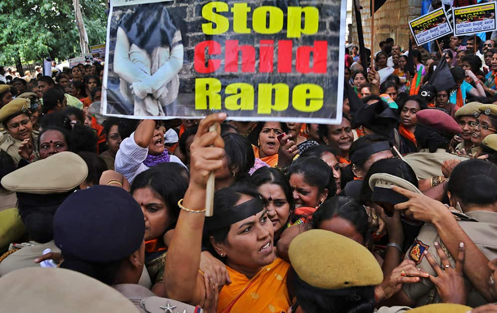 Women activists of Bhartiya Janata Party (BJP) scuffle with policewomen as they are prevented to proceed during a protest against recent incidents of rape of schoolgirls, in Bangalore.