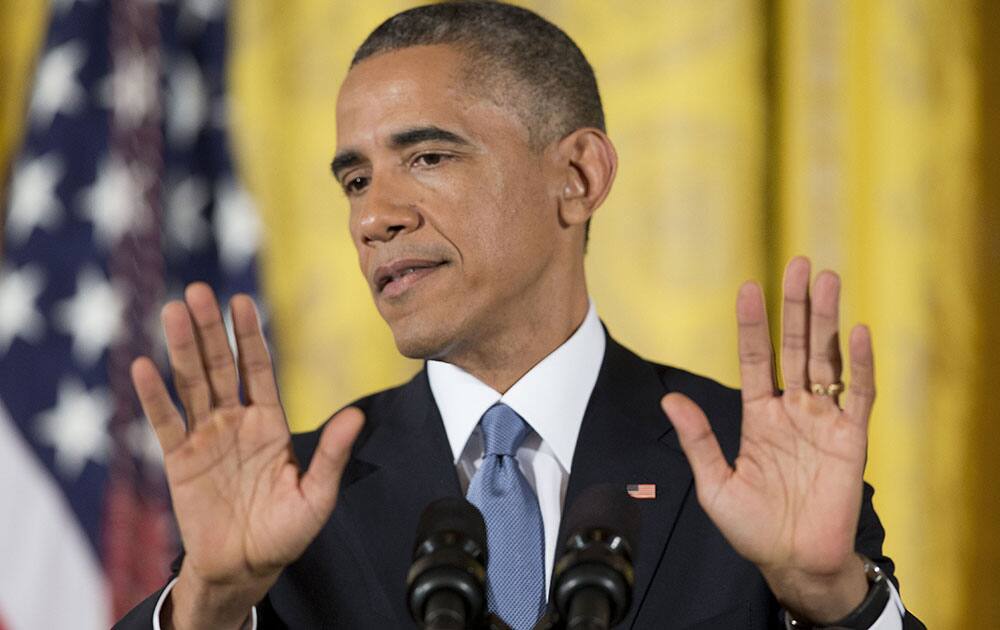 President Barack Obama gestures as he speaks during a news conference in the East Room of the White House, in Washington. 