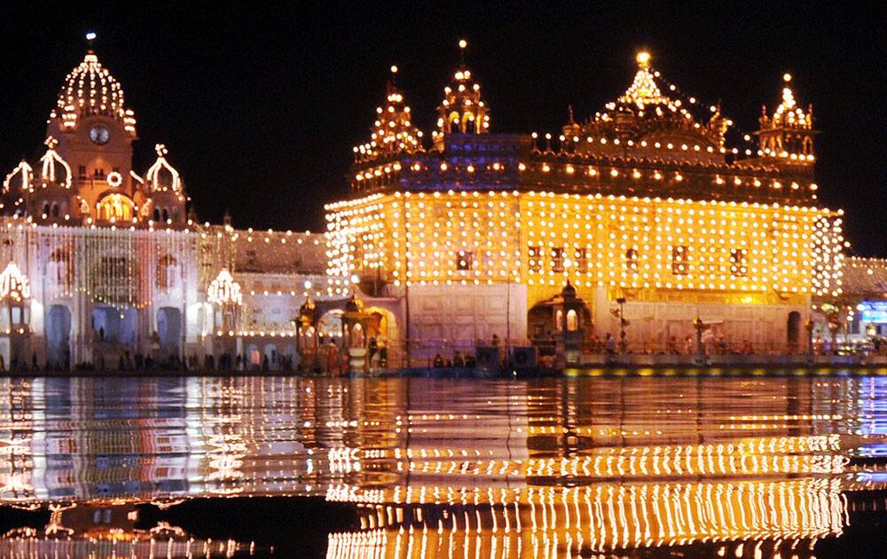 Golden Temple is illuminated on the eve of the birth anniversary of Guru Nanak Dev Ji in Amritsar.