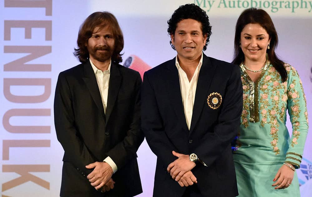 Cricket legend Sachin Tendulkar with wife Anjali and elder brother Ajit Tendulkar during the release of his autobiography Playing It My Way in Mumbai.