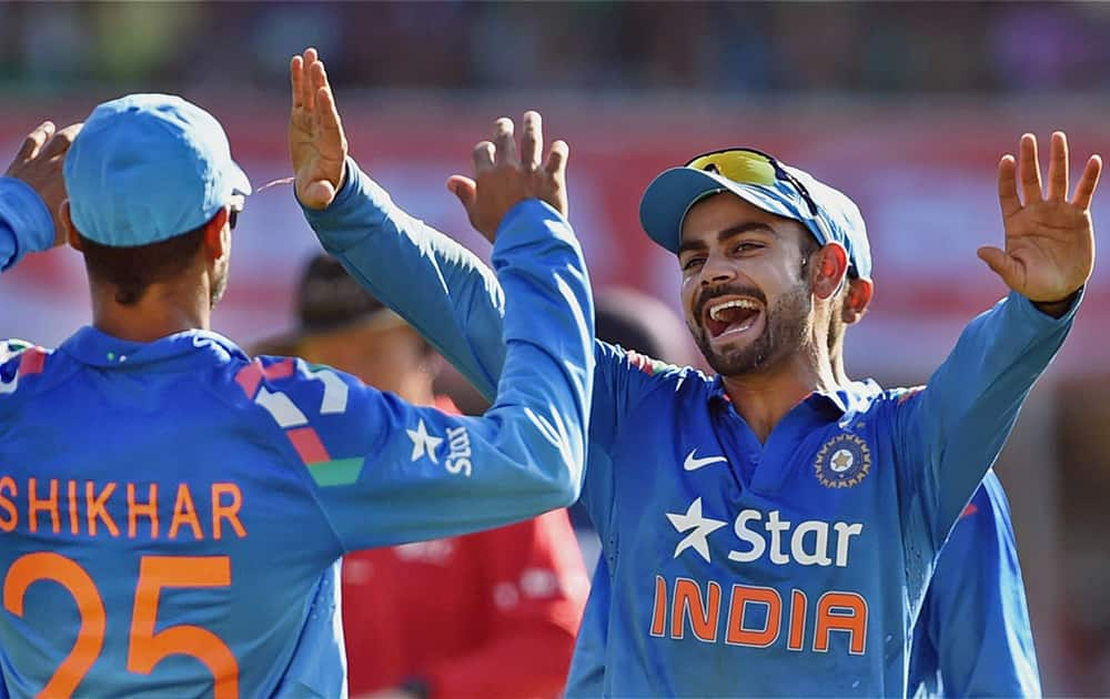 Indian captain Virat Kohli celebrates the wicket of Sri Lankan batsman Sangakkara during the ODI cricket match in Ahmedabad.