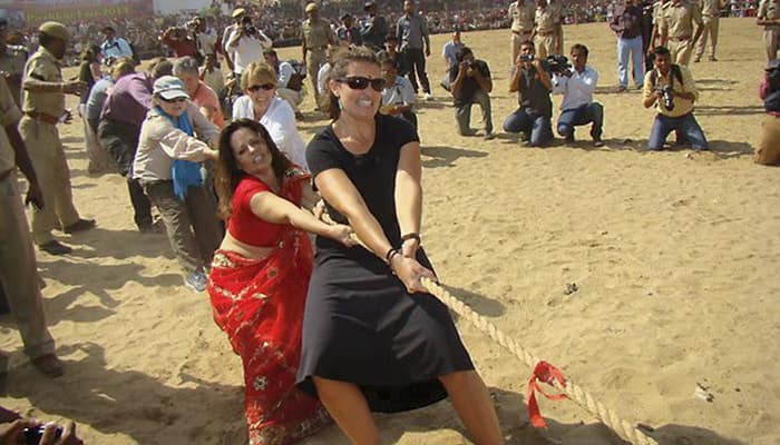 Foreign tourists participate in a Tug of War competition at the Pushkar Fair.