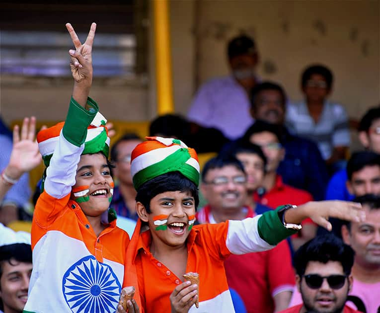 Young children cheer for team India during the 2nd ODI cricket match between India and Sri Lanka in Ahmedabad.