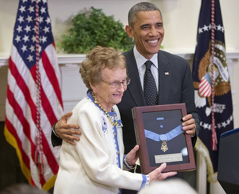 President Barack Obama stands with Helen Loring Ensign, 85, from Palm Desert, Calif., as he awards the Medal of Honor posthumously to Army First Lt. Alonzo H. Cushing for conspicuous gallantry, during a ceremony in the East Room of the White House in Washington.