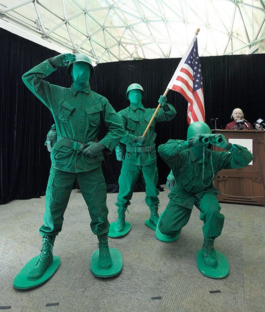 Actors portraying little green army men pose at the National Museum of Play at The Strong, in Rochester, N.Y. The molded plastic must-haves for generations of pretend soldiers were inducted into the National Toy Hall of Fame on Thursday, along with the 1980s stumper Rubik's Cube, and bubbles.