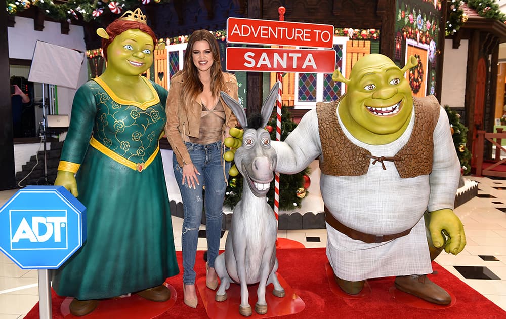 Khloe Kardashian is all smiles with Shrek, Donkey and Princess Fiona as she visits Adventure to Santa, a DreamWorks DreamPlace at Glendale Galleria in Los Angeles.