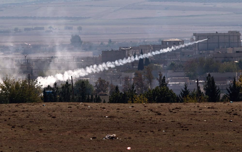 A missile is fired from Islamic State positions in Kobani, seen from a hilltop outside Suruc, on the Turkey-Syria border.