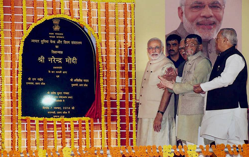 Prime Minister Narendra Modi with MoS Textiles, Santosh Kumar Gangwar lays the foundation stone of a trade facilitation centre for weavers as looks on.