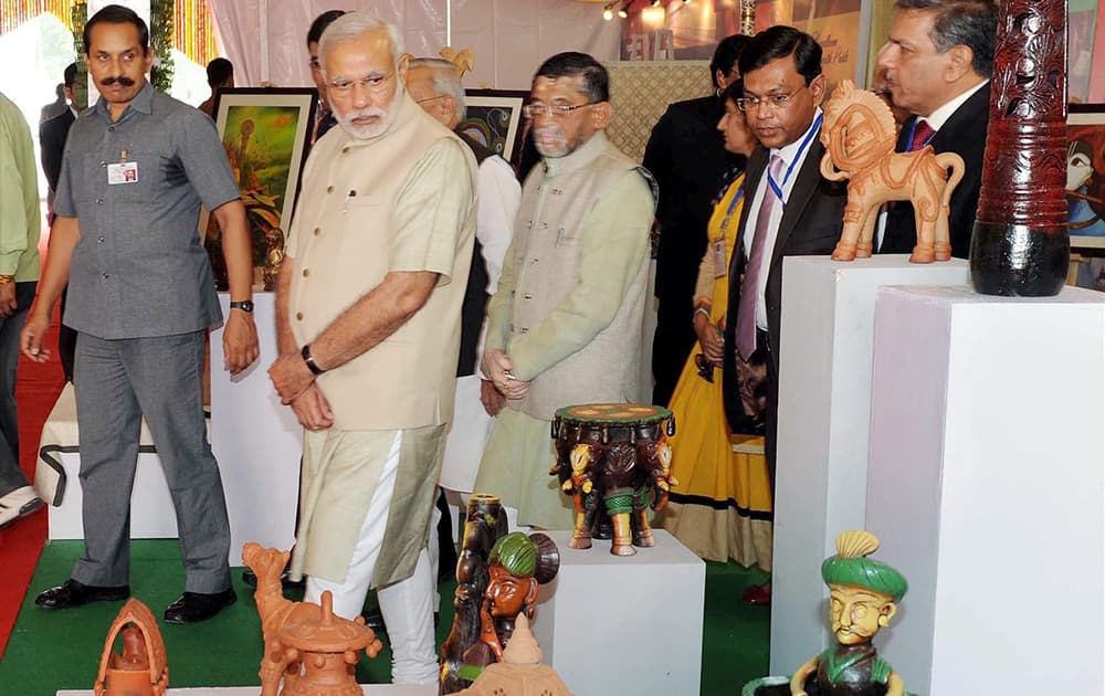 Prime Minister Narendra Modi visits an exhibition during foundation stone laying ceremony of Trade Facilitation Center and Crafts Museum and inauguration of Powerloom Service Center, in Varanasi.