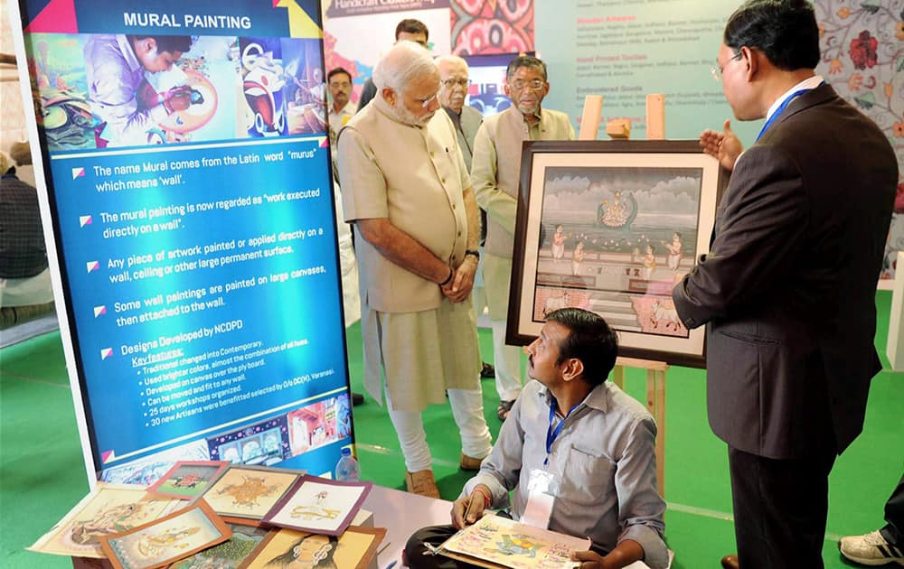 Prime Minister Narendra Modi visits an exhibition during foundation stone laying ceremony of Trade Facilitation Center and Crafts Museum and inauguration of Powerloom Service Center, in Varanasi.