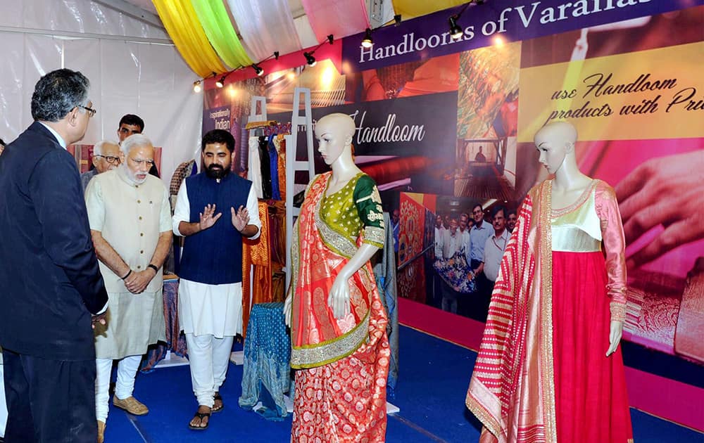 Prime Minister Narendra Modi visits an exhibition during foundation stone laying ceremony of Trade Facilitation Center and Crafts Museum and inauguration of Powerloom Service Center.