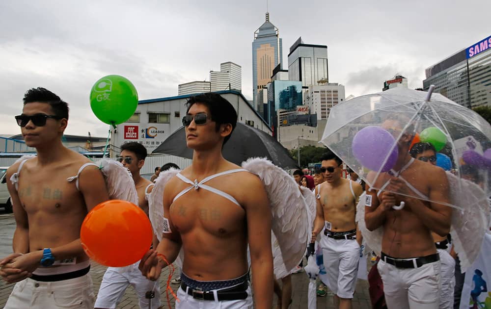 Participants hold balloons marching during a gay rally in Hong Kong.
