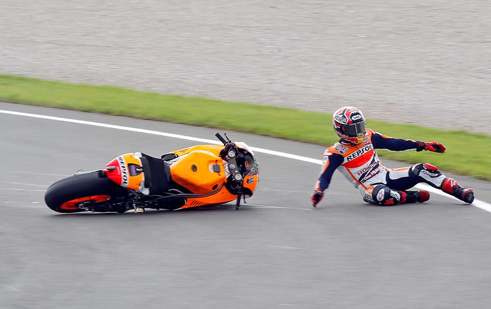 Moto GP rider Marc Marquez of Spain falls from his bike during free practice at Spain's Valencia Motorcycle Grand Prix, the last race of the season, at the Ricardo Tormo circuit in Cheste near Valencia, Spain.