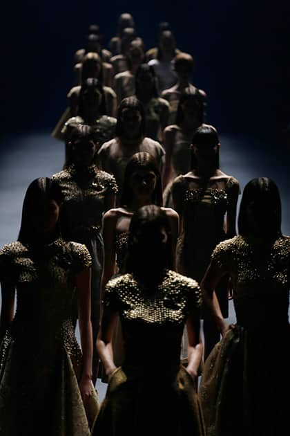 Models wear creations from the Acquastudio Winter collection during the Sao Paulo Fashion Week in Sao Paulo, Brazil.