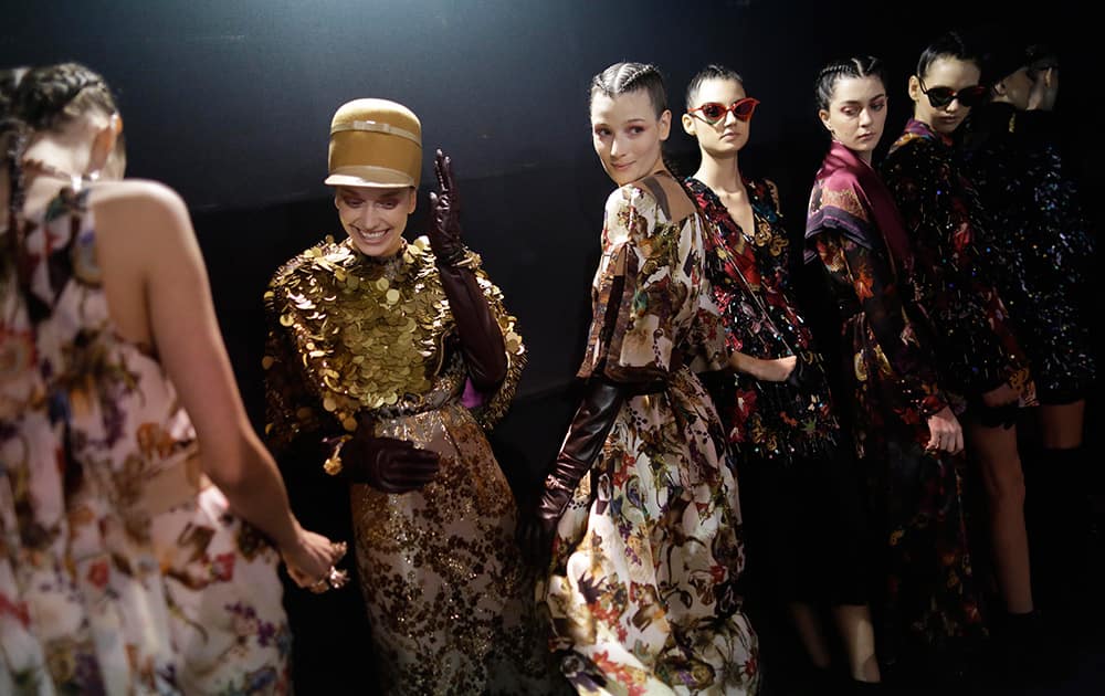 Models wait backstage to take the catwalk for the presentation of Teca by Helo Rocha at a Sao Paulo fashion week’s fall-winter show, in Sao Paulo, Brazil. 