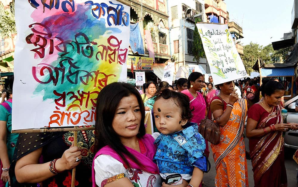 A Sex Worker with her child during a rally to support the National Commission for Women Chairperson Lalitha Kumarmangalams proposal on legalisation of Sex work in Kolkata.