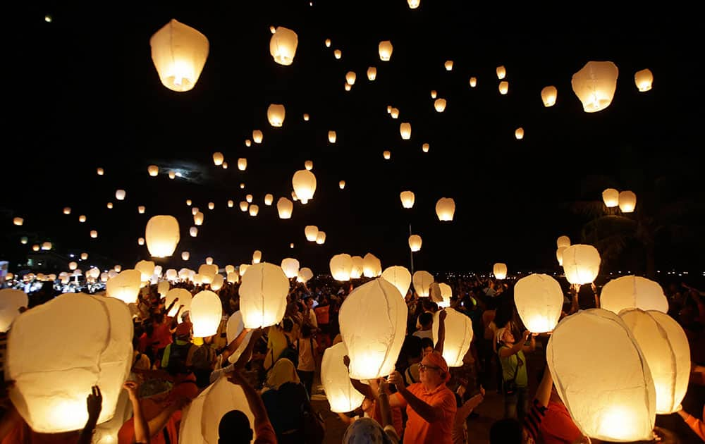 Survivors release floating lanterns into the sky Saturday, Nov. 8, 2014 at Tacloban city, Leyte province in central Philippines, to commemorate the 1st anniversary when Typhoon.