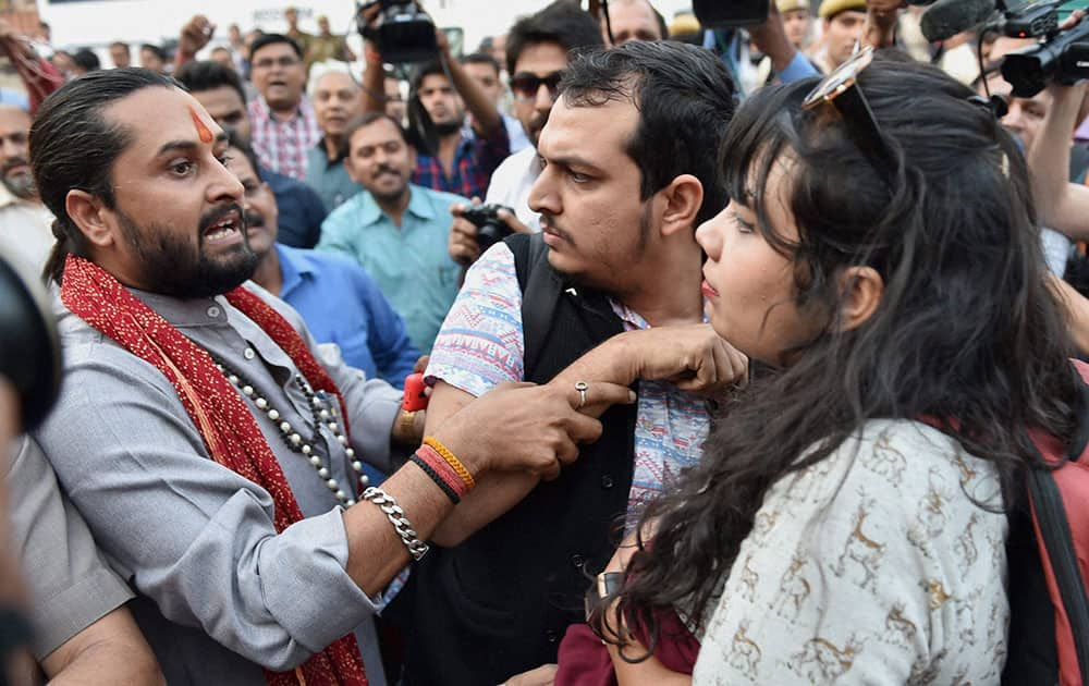 Kiss of Love (campaign against moral policing) activists (R) and Hindu activists (L) argue outside RSS headquarters.