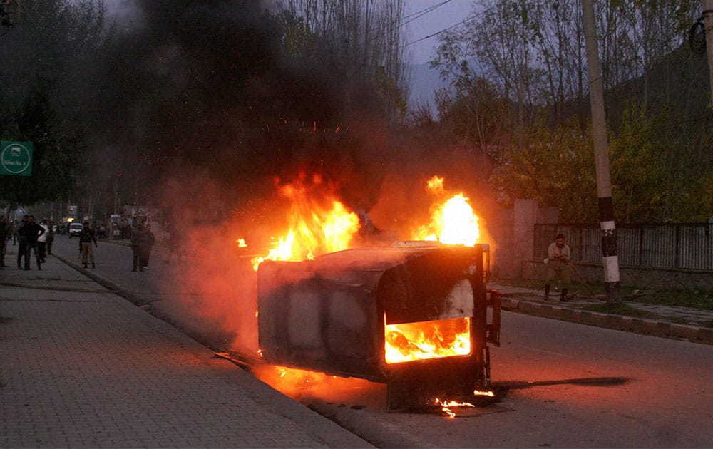 A CRPF vehicle in flames after it was set ablaze by a mob protesting against the killing of two youths by the army.