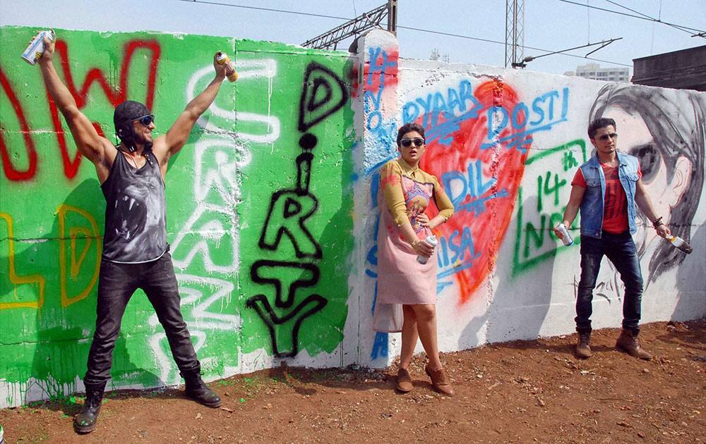 Bollywood actors Ranveer Singh, Parineeti Chopra and Ali Zafar paint graffitis on wall.