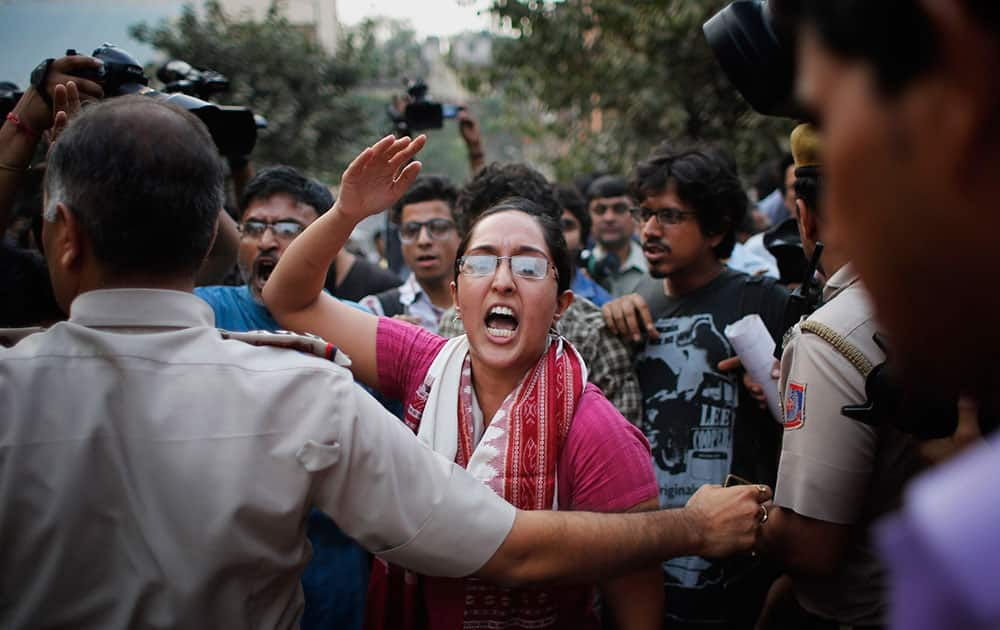 An activists expressing support to the 'Kiss of Love' campaign  shouts slogans as she is prevented from from marching towards the Hindu right-wing Rashtriya Swayamsevak Sangh (RSS) headquarters in New Delhi.