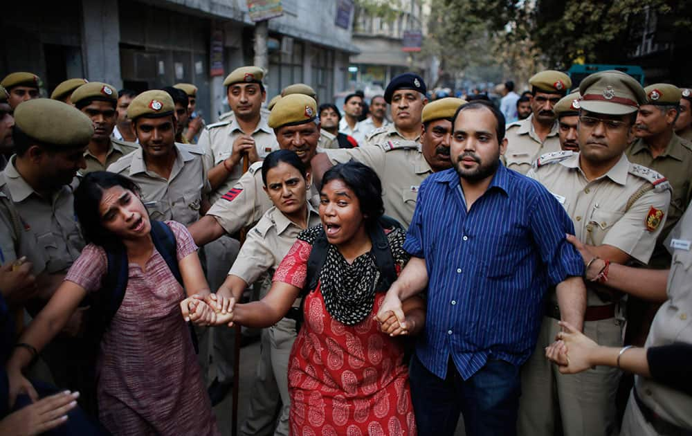 Activists expressing support to the 'Kiss of Love' campaign  lock hands and shout slogans after police prevented them from marching towards the Hindu right-wing Rashtriya Swayamsevak Sangh (RSS) headquarters in New Delhi.