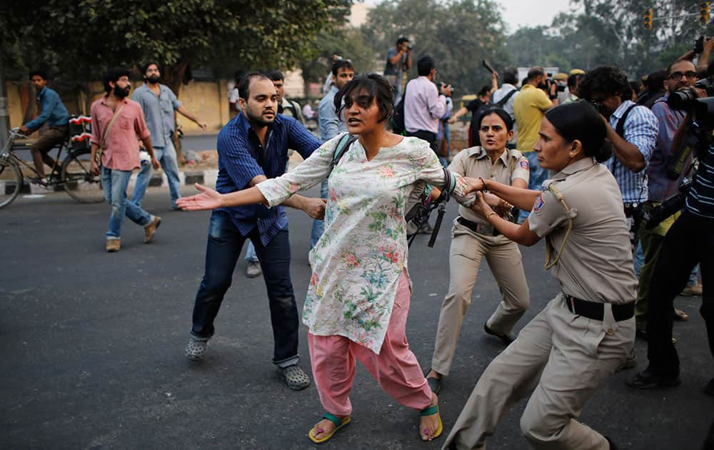 Policewomen prevent an activists expressing support to the 'Kiss of Love' campaign  from marching towards the Hindu right-wing Rashtriya Swayamsevak Sangh (RSS) headquarters in New Delhi.