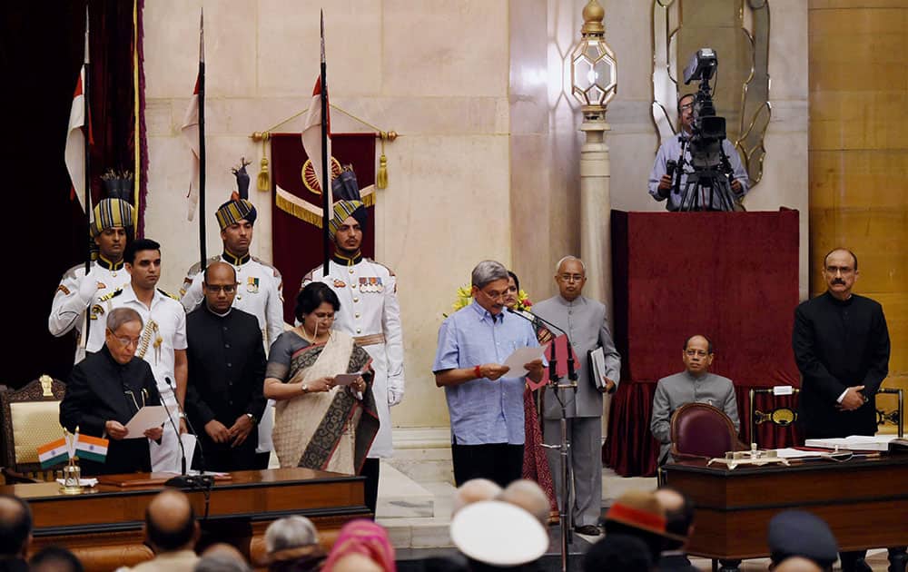 President Pranab Mukherjee administers oath to new Cabinet minister Manohar Parrikar at the swearing-in ceremony at Rashtrapati Bhavan in New Delhi.