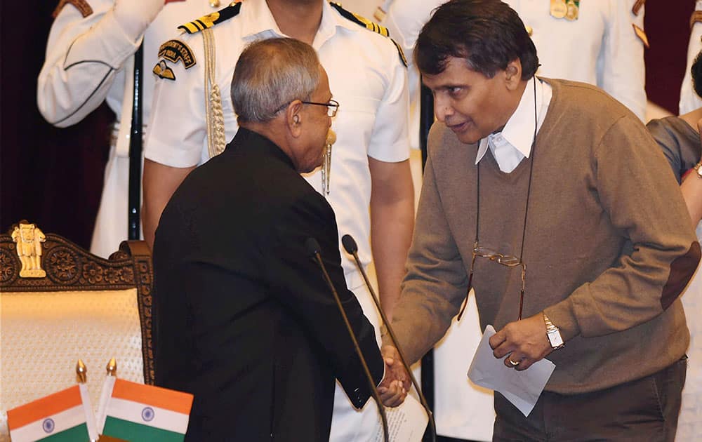 President Pranab Mukherjee shakes hands with the new Cabinet minister Suresh Prabhu after administering him oath of office at the swearing-in ceremony at Rashtrapati Bhavan in New Delhi.
