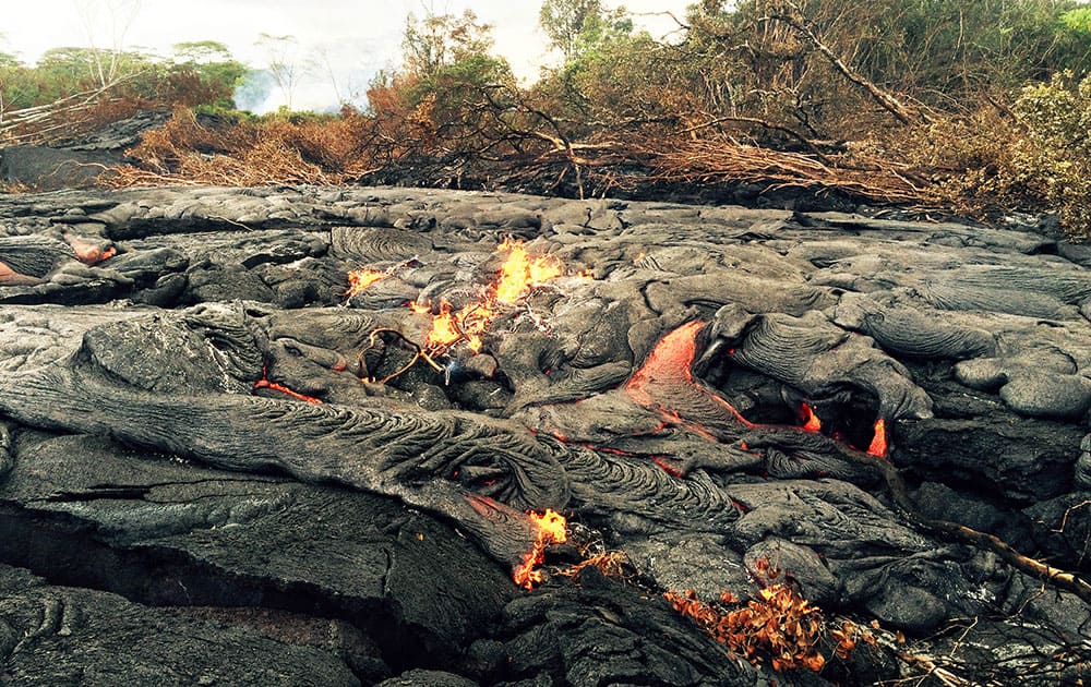 This photo from the US Geological Survey shows a breakout, or area where lava oozes to the side of a flow upslope of the stalled leading edge, about 400 meters (0.25 miles) upslope of Cemetery Road near the town of Pahoa on the Big Island of Hawaii.