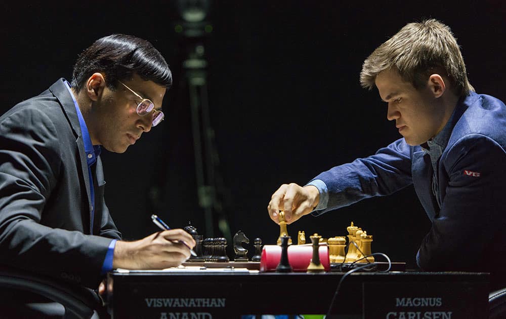 Norway's Magnus Carlsen, currently the top ranked chess player in the world, right, makes a move as he plays against India's former World Champion Vishwanathan Anand at the FIDE World Chess Championship Match in Sochi, Russia.